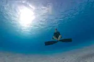 Freediver meditating underwater