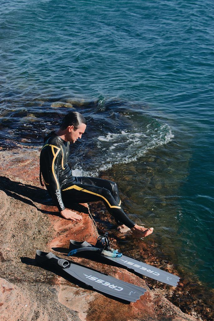 Man in one piece wetsuit