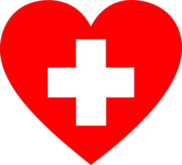 Red love heart with white cross in it symbolizing first aid and safety.